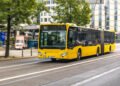 Ônibus urbano articulado amarelo transporte público no centro da cidade